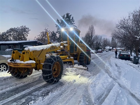 Taken yesterday, this photo shows a road grader clearing a residential street as crews worked to improve conditions citywide.