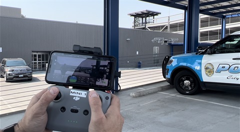 Officer holding drone remote.jpeg