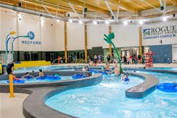Multiple kids playing in recreation pool.
